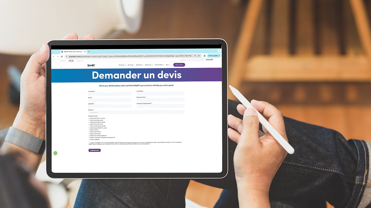 A person holding a tablet displaying the SMART 'Request a Quote' page, showcasing fields for submitting business/organization details.