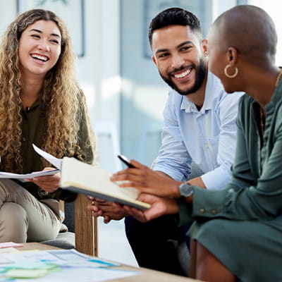 Image of three individuals collaborating in a professional setting.