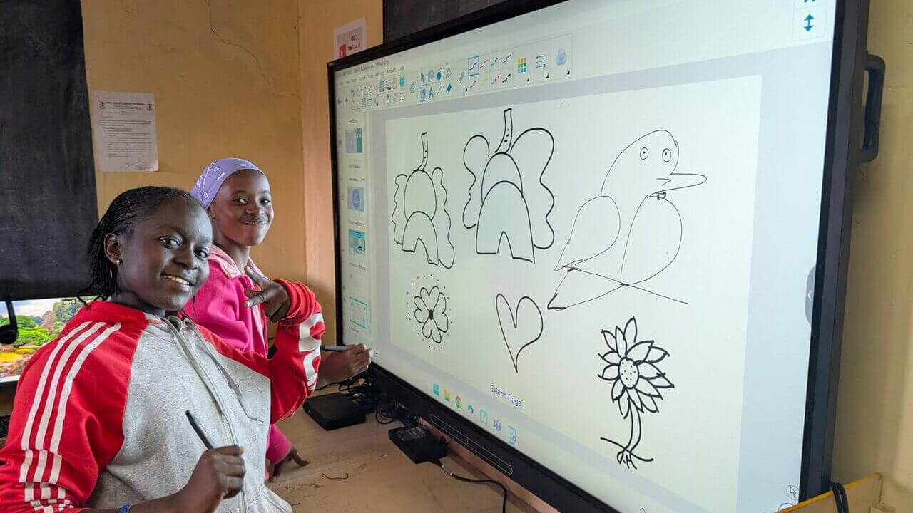 Kids in a classroom in Kenya with a SMART Board