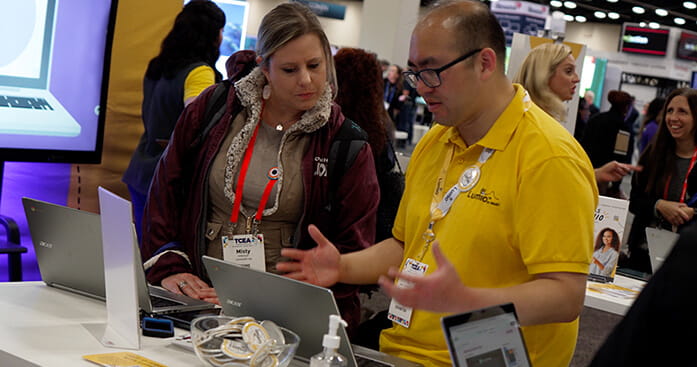 Image of a Lumio employee showcasing software.