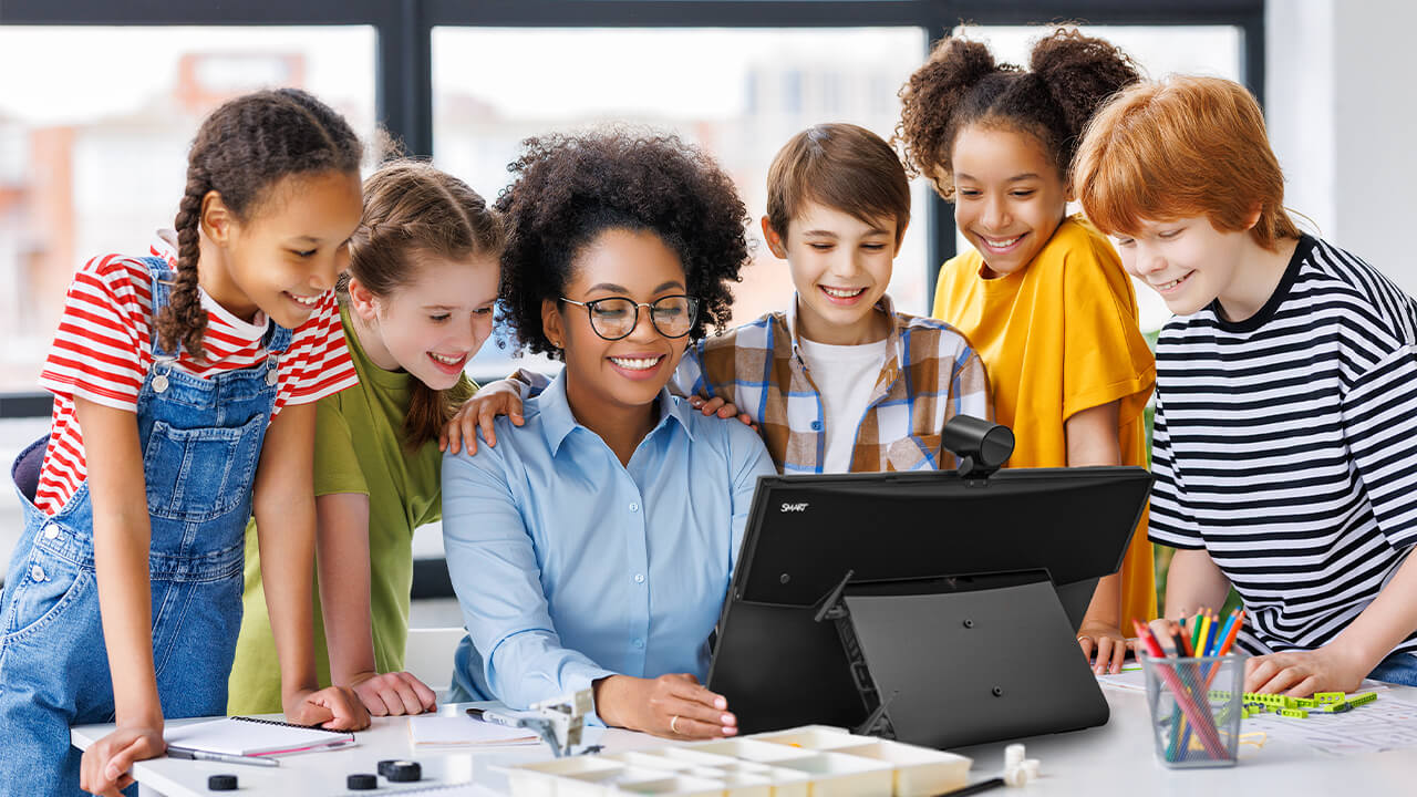 Teacher guiding students with the SMART Board Mini Interactive Podium in an inclusive classroom.