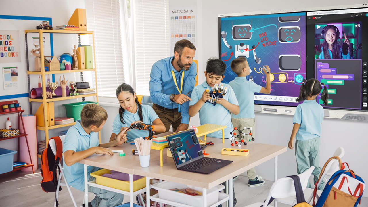 Teacher with students in class with a SMART Board